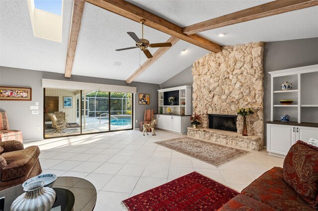 7300 Wax Myrtle Way, Sarasota, FL 34241 - living area featuring light tile patterned flooring, a ceiling fan, a textured ceiling, and a stone fireplace