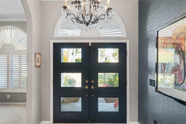 7300 Wax Myrtle Way, Sarasota, FL 34241 - tiled foyer with french doors, arched walkways, and a chandelier