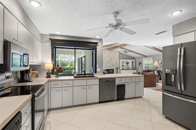 7300 Wax Myrtle Way, Sarasota, FL 34241 - kitchen featuring stainless steel appliances, a ceiling fan, a peninsula, light countertops, and open floor plan