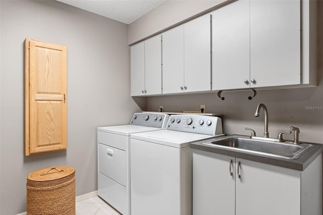 7300 Wax Myrtle Way, Sarasota, FL 34241 - washroom featuring separate washer and dryer, cabinet space, light tile patterned flooring, and a textured ceiling