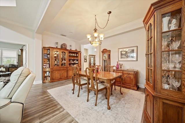 4691 Claremont Park Dr, Bradenton, FL 34211 - dining space featuring a chandelier, light wood-style flooring, and crown molding