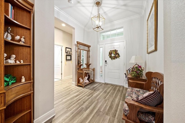 4691 Claremont Park Dr, Bradenton, FL 34211 - foyer entrance with ornamental molding, a chandelier, and light wood-style floors