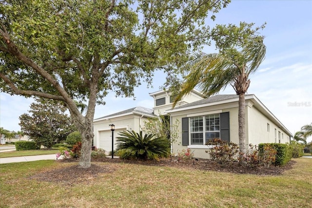 4691 Claremont Park Dr, Bradenton, FL 34211 - view of front of house with an attached garage, stucco siding, and a front yard