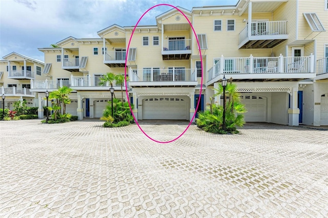 view of front facade with decorative driveway and a garage