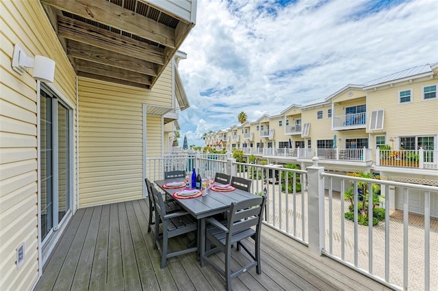 wooden deck featuring a residential view and outdoor dining space