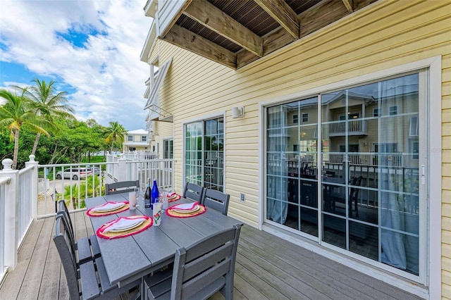 wooden deck featuring outdoor dining area