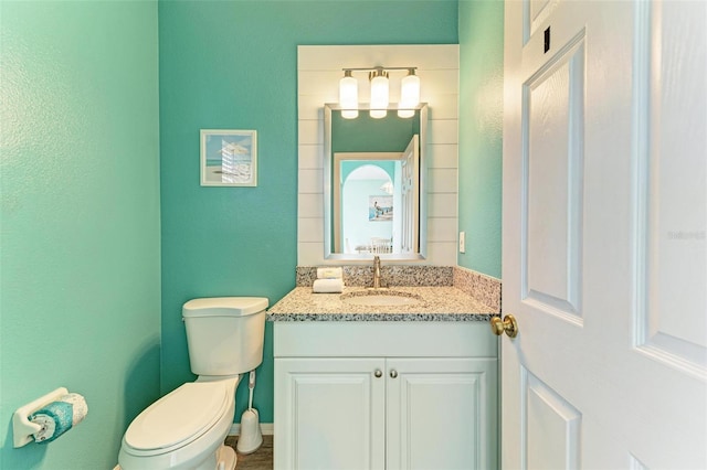 bathroom featuring toilet and vanity