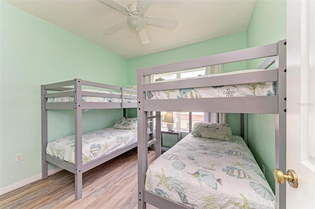 bedroom featuring a ceiling fan, wood finished floors, and baseboards