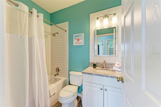 bathroom featuring toilet, shower / bath combo, and vanity