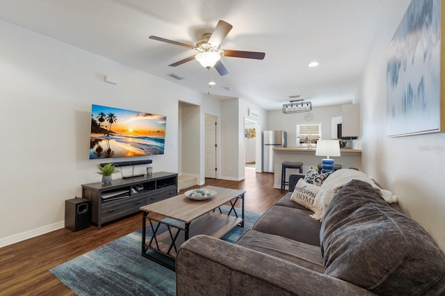 living area featuring a ceiling fan, recessed lighting, wood finished floors, and baseboards