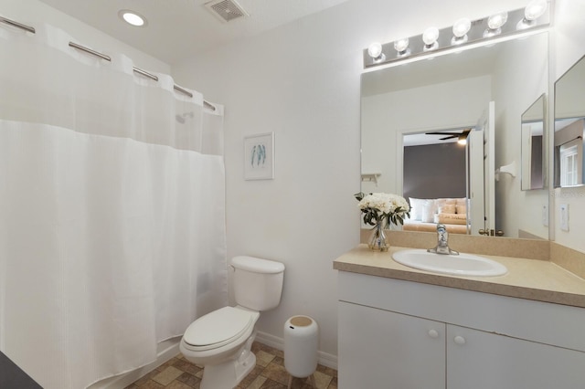 ensuite bathroom with vanity, baseboards, visible vents, toilet, and connected bathroom