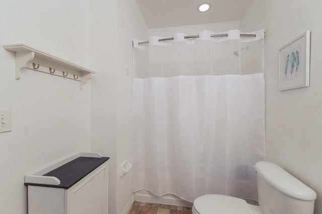 bathroom with recessed lighting, toilet, and shower / bathtub combination with curtain