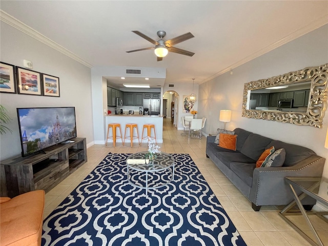 13415 Blue Heron Beach Dr Unit 1407, Orlando, FL 32821 - living area with arched walkways, light tile patterned floors, crown molding, and visible vents