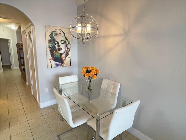 13415 Blue Heron Beach Dr Unit 1407, Orlando, FL 32821 - dining space with light tile patterned floors, baseboards, visible vents, arched walkways, and a notable chandelier