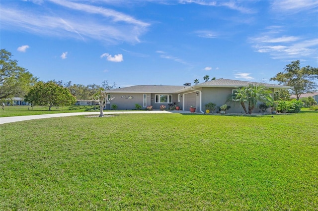 ranch-style house with a front yard, an attached garage, driveway, and stucco siding