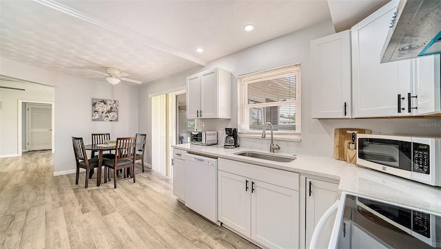 22201 Olean Blvd, Port Charlotte, FL 33952 - kitchen with white appliances, light wood-type flooring, white cabinets, and a sink