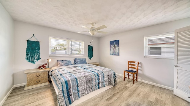 22201 Olean Blvd, Port Charlotte, FL 33952 - bedroom featuring a textured ceiling, baseboards, ceiling fan, and light wood-type flooring