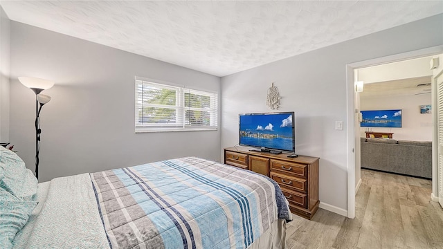 22201 Olean Blvd, Port Charlotte, FL 33952 - bedroom featuring baseboards, light wood finished floors, and a textured ceiling