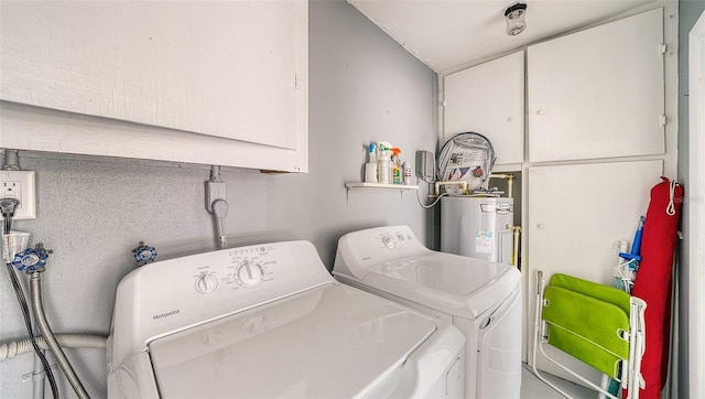 22201 Olean Blvd, Port Charlotte, FL 33952 - clothes washing area featuring water heater, independent washer and dryer, and cabinet space