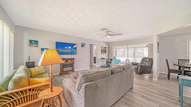 22201 Olean Blvd, Port Charlotte, FL 33952 - living room featuring baseboards, light wood-style flooring, visible vents, and a ceiling fan