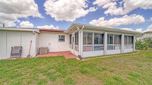 22201 Olean Blvd, Port Charlotte, FL 33952 - back of house with central air condition unit, stucco siding, a sunroom, a patio, and a yard