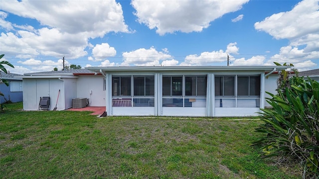 22201 Olean Blvd, Port Charlotte, FL 33952 - rear view of house featuring central air condition unit, stucco siding, a sunroom, and a yard