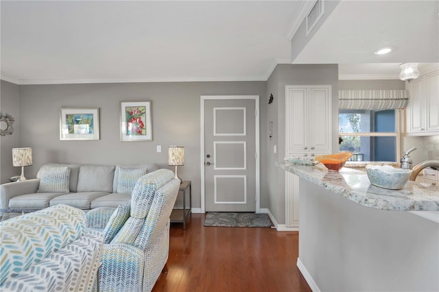 living area featuring dark wood-style floors, visible vents, crown molding, and baseboards