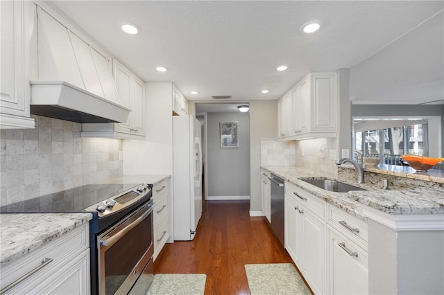 kitchen featuring premium range hood, dark wood-style flooring, a sink, stainless steel appliances, and white cabinets