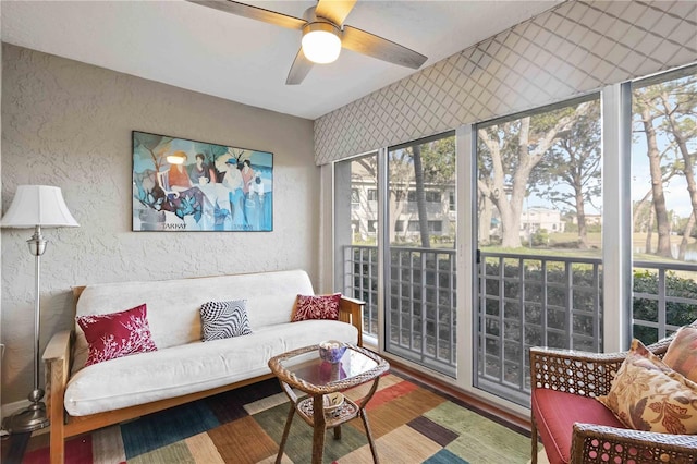 interior space featuring a healthy amount of sunlight, ceiling fan, and a textured wall