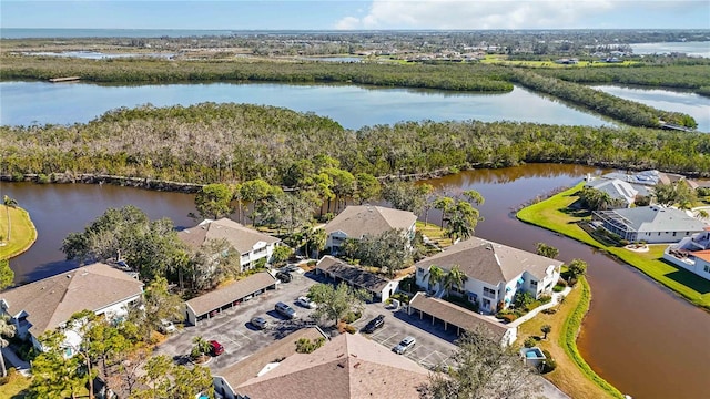 drone / aerial view featuring a residential view and a water view