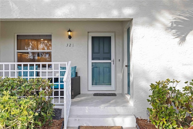 property entrance featuring stucco siding