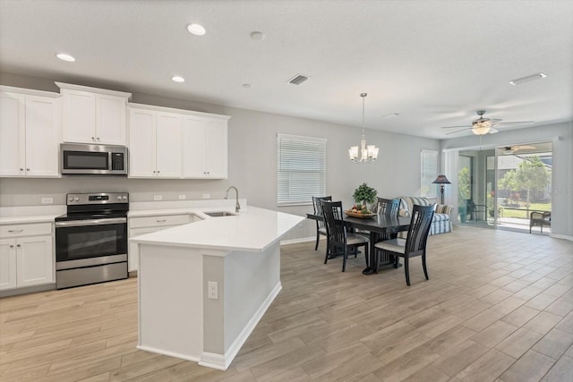 5998 Amberly Dr, Bradenton, FL 34208 - kitchen with a sink, light countertops, light wood finished floors, and stainless steel appliances