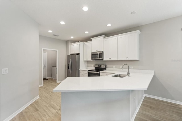 5998 Amberly Dr, Bradenton, FL 34208 - kitchen featuring a sink, light countertops, light wood-type flooring, and stainless steel appliances