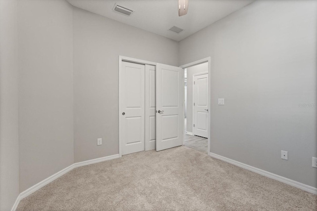 5998 Amberly Dr, Bradenton, FL 34208 - unfurnished bedroom with baseboards, visible vents, a closet, and light carpet