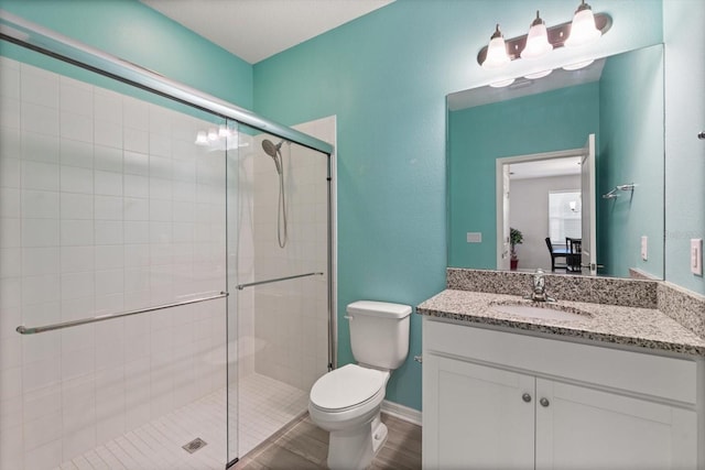 5998 Amberly Dr, Bradenton, FL 34208 - full bath featuring wood finished floors, toilet, a stall shower, and vanity