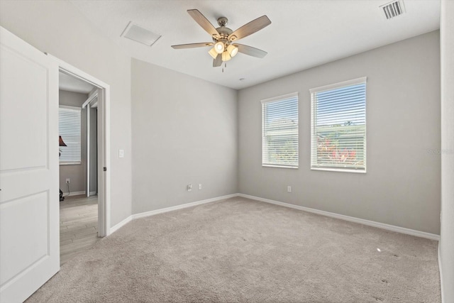 5998 Amberly Dr, Bradenton, FL 34208 - spare room featuring visible vents, light colored carpet, a ceiling fan, and baseboards