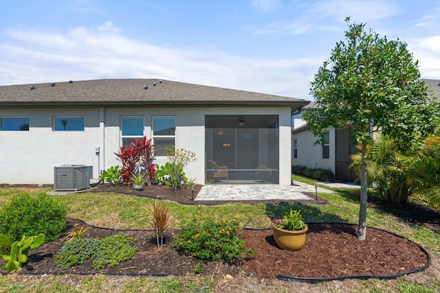 5998 Amberly Dr, Bradenton, FL 34208 - back of house featuring roof with shingles, stucco siding, cooling unit, a sunroom, and a patio area