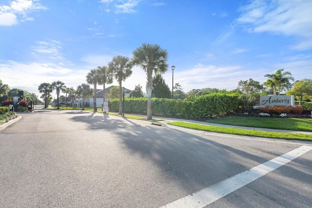 5998 Amberly Dr, Bradenton, FL 34208 - view of road with a gated entry, curbs, street lighting, and a gate