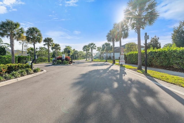 5998 Amberly Dr, Bradenton, FL 34208 - view of street with curbs, a gated entry, traffic signs, and a gate