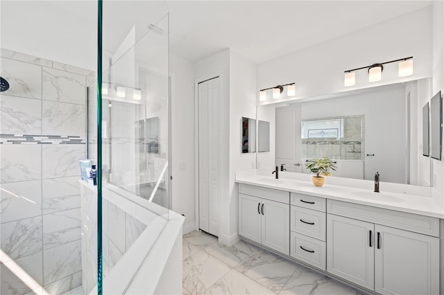 bathroom with a sink, marble finish floor, double vanity, and a tile shower