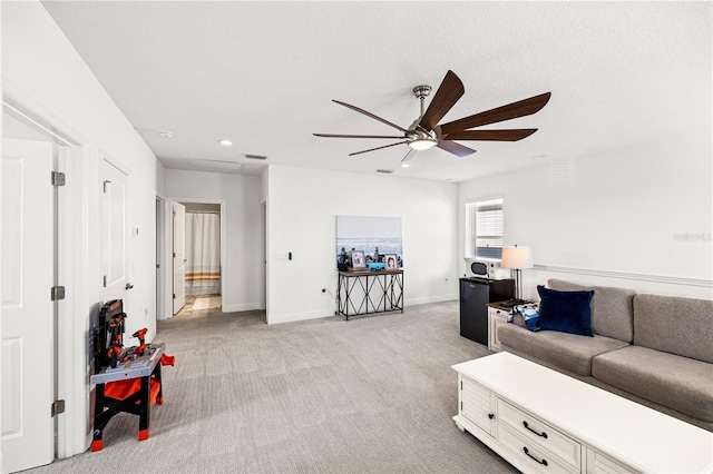 living area with a ceiling fan, visible vents, baseboards, recessed lighting, and light carpet