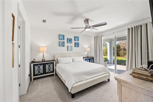 bedroom featuring light colored carpet, a ceiling fan, visible vents, and access to exterior