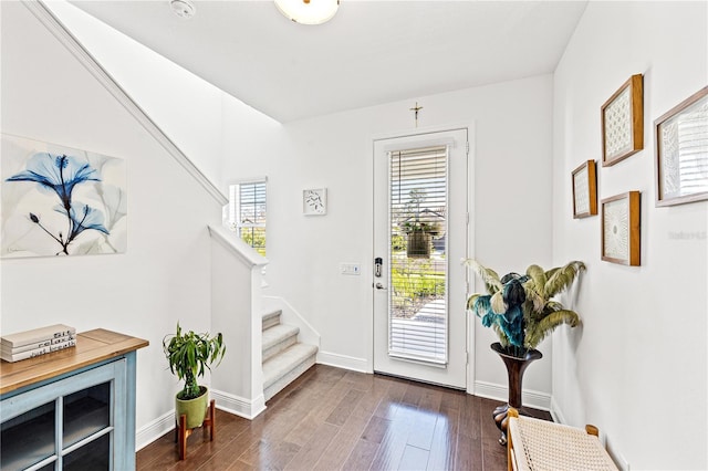 foyer featuring stairs, baseboards, and dark wood finished floors