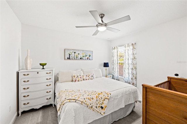 carpeted bedroom with baseboards and a ceiling fan