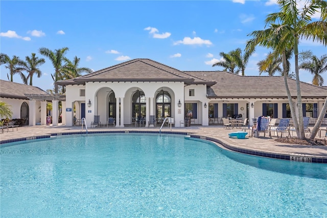 pool featuring a patio and a pergola