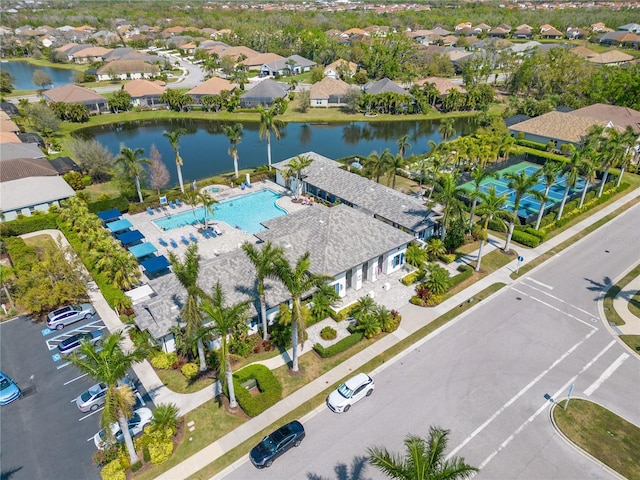drone / aerial view with a water view and a residential view