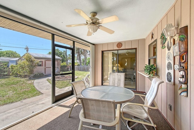 sunroom featuring ceiling fan