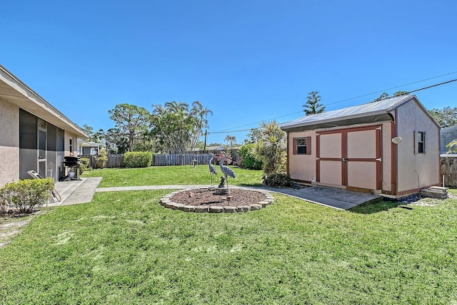 view of yard with a patio area, a storage shed, an outdoor structure, and fence