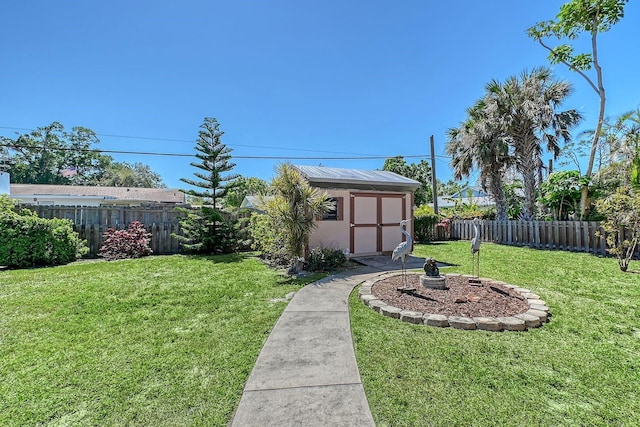 view of yard featuring an outbuilding, a storage unit, and a fenced backyard