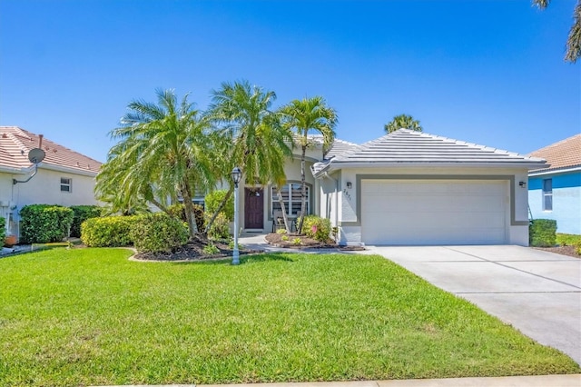 view of front of property with stucco siding, driveway, a front lawn, an attached garage, and a tiled roof